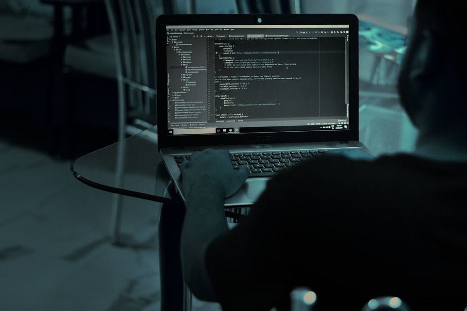 Programmer with laptop developing website